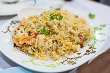 Fried rice with shrimp and egg on the white dish