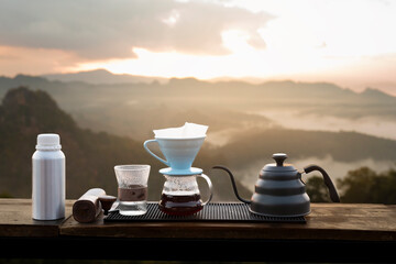 A set of coffee drip equipment with blurred nature background