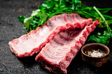 Raw ribs with herbs and spices. 