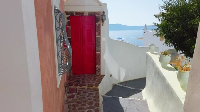 Impressive Greek Style Door Casing with Deep Red Door on Pure White Building at Santorini, Greece