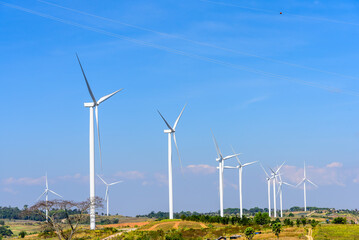 Fototapeta premium Windmills for clean electric power production. Windmill wind turbine for eco energy green and clean energy environment concervation climate change concept.