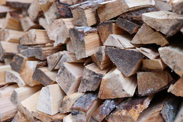 Stacked firewood close up as background.