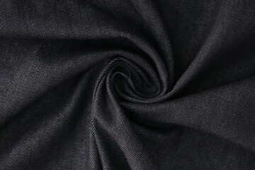 Swirled gray denim fabric as background.