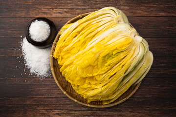 Kimchi Cabbage. Korean traditional way, salted cabbage. Wood deck background, closeup viewed from...