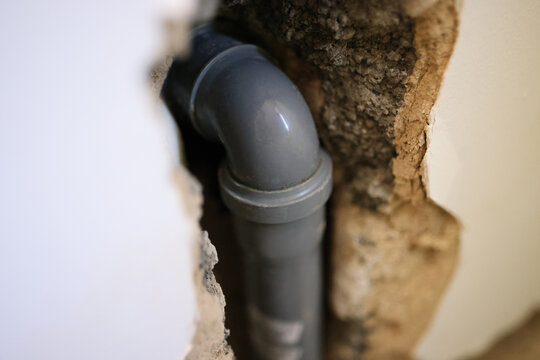 PVC pipe in wall of house close up.