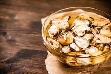 Pickled mussels in a glass bowl. 