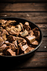 Liver fried in a frying pan. 