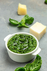 Homemade pesto sauce and ingredients, Traditional Italian pesto recipe for pasta on a dark background, vertical image. top view. place for text