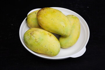 Ripe Mangoes on white plate