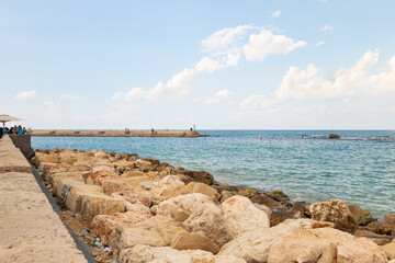 Fototapeta premium Promenade in the old town of Yafo and the skyscrapers of Tel Aviv in the distance, in Tel Aviv - Yafo city, Israel