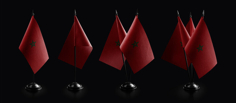 Small national flags of the Morocco on a black background