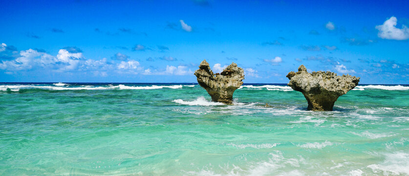 Heart rock shape at Tinuhama beach, Kouri Island, Okinawa prefecture, Japan, one of the tourist spot attractions and landmarks of Okinawa near the beach with clear blue sky and clear sea.
