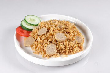 Nasi Goreng Bakso is Fried Rice with Meat Ball garnished with fresh cucumber and tomatoes slices.