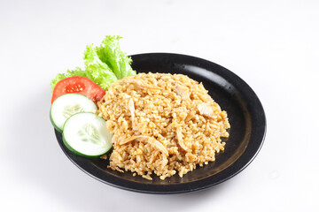 Nasi Goreng Ayam is Fried Rice with chicken meat garnished with fresh cucumber and tomatoes slices.