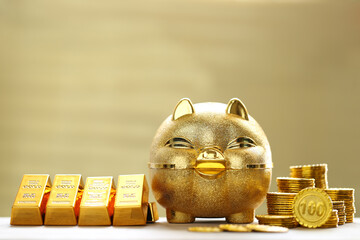 Saving gold, Golden piggy banks and have gold bars with stack of coins money on yellow background,...