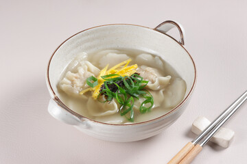 Tteok Mandu Guk is korean Rice Cake Soup with Dumplings in Beef Broth.