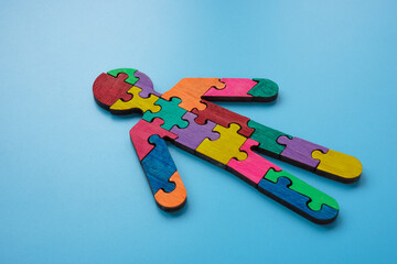 Figure of a man made of multi-colored puzzle pieces. Autism or neurodiversity concept.