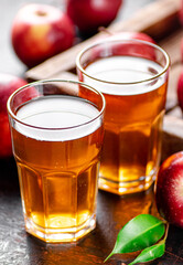 A glass of apple juice on the table. 