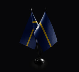 Small national flags of the Nauru on a black background