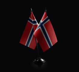 Small national flags of the Norway on a black background