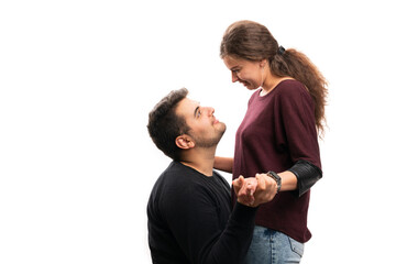 Male model kneeling in front of smiling girlfriend with copyspace
