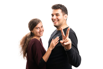 Cheerful couple smiling boyfriend making peace or victory sign