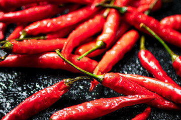 Pods of hot chili peppers on the table. 