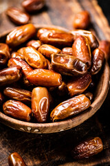 Dates in a plate on a cutting board. 