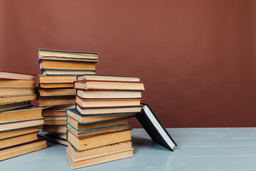 a stack of old instructional books on a brown background