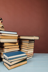 a stack of old instructional books on a brown background