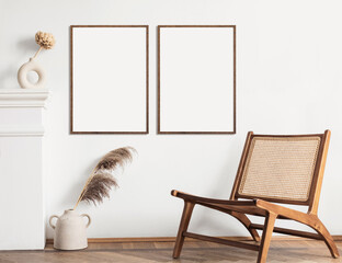 Blank picture frame mockup on white wall. Modern living room design. View of modern Boho style...