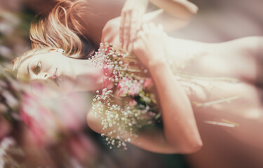 Young woman with bouquet of flowers. Double exposure effect.