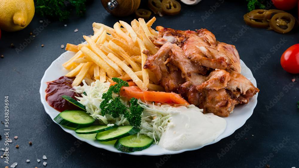 Sticker fried chicken fillet with french fries, tomatoes, cabbage, cucumbers, ketchup and mayonnaise.