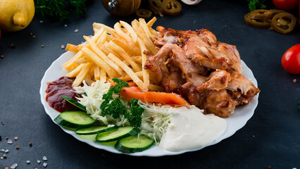 Fried chicken fillet with french fries, tomatoes, cabbage, cucumbers, ketchup and mayonnaise.