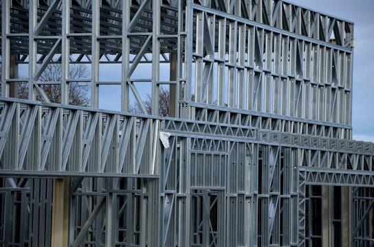 Building construction from metal trusses. lattice structure of the frame of an industrial building. A large thick tangle on the ceiling of a building under construction. shiny metal profiles steel