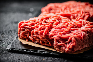 Raw minced meat on a stone board. 