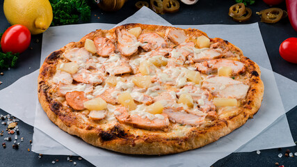 Italian pizza with chicken, pineapple, cheese and sauce.