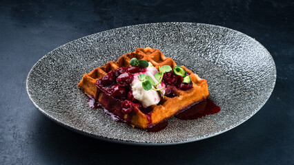 Belgian waffles with cream cheese and cherry jam.