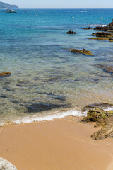 A little boat in the bay with sand beach in the morning. Sunny summer vacation