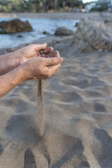 Sand falling from male hands at beach