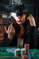 image of a young sexy woman playing poker with a cigarette and smoke coming out of it. poker in the...