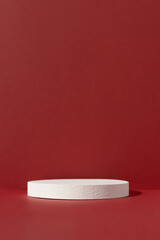 Geometric white podium on an abstract red background. Empty scene for the product presentation. Showcase, display case.