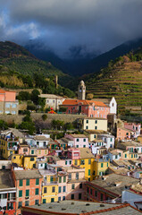 Fototapeta na wymiar Aerial landscape of Vernazza village. Ancient buildings between mountains and the sea. Famous touristic place and travel destination in Italy. Vernazza, Cinque Terre. UNESCO World Heritage Site