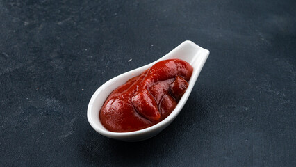 Ketchup sauce in a small ceramic bowl.