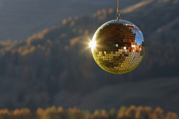 Golden disco mirror ball with mountain forest background
