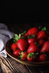 A bowl with ripe bright strawberry in rustic style	