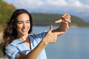 Happy woman framing with hands calculating perspective
