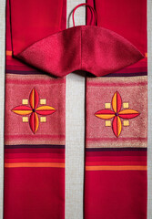 Red liturgical stole of a catholic priest with two crosses