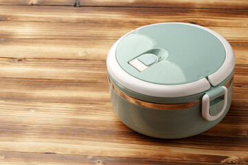 New empty plastic lunch box on a wooden background