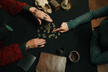 Old mature witch giving prediction using spiritual attributes closeup top view